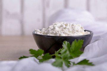 A fresh ricotta cheese with parsley leaf on white marble table