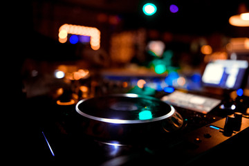 Fototapeta na wymiar club DJ in headphones with sound mixer in nightclub