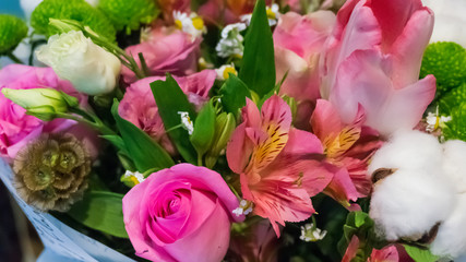 Roses and buds of natural white cotton in a bouquet of flowers