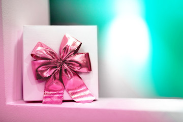 Gift box with pink bow on a blue background.
