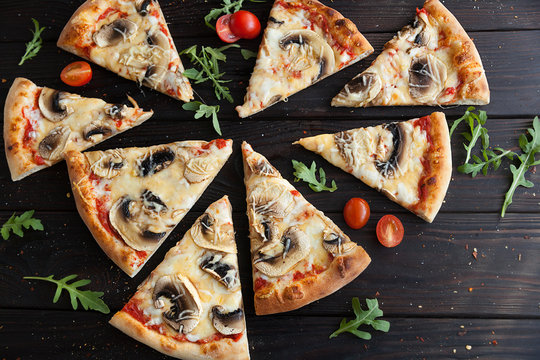 pizza, fresh mushroom pizza with mozzarella, champignons and cheese. Italian pizzeria. Fresh pizza on the kitchen table
