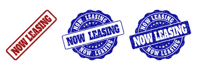 NOW LEASING scratched stamp seals in red and blue colors. Vector NOW LEASING labels with draft surface. Graphic elements are rounded rectangles, rosettes, circles and text labels.