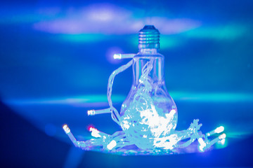 Colorful light bulb on the dark background.