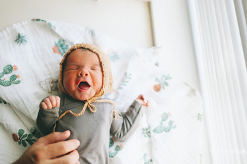 A newborn baby yawning