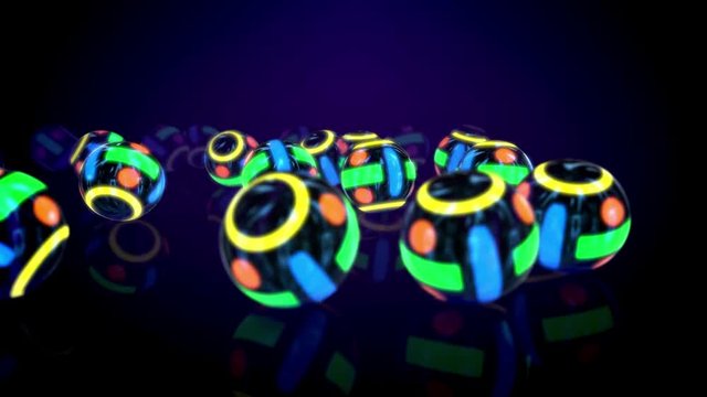 Amazing 3d rendering of a group of neon looking colorful balls put on flat surface in the black background in seamless loop. They create the spirit of innovation, fun and optimism.