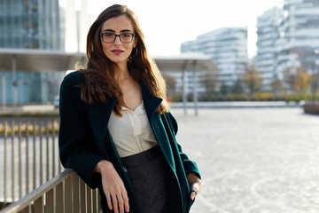 Portrait of a confident business woman wearing glasses in and urban scene
