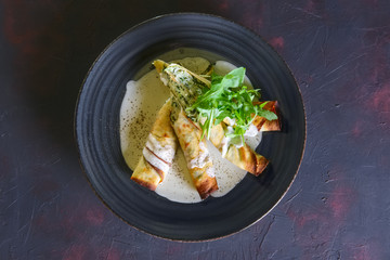 Thin pancakes stuffed with arugula and cheese