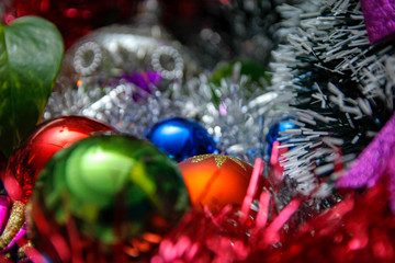 Fototapeta na wymiar Christmas balls in various of colors and other holiday ornaments. Winter holiday decoration for Christmas and new year.