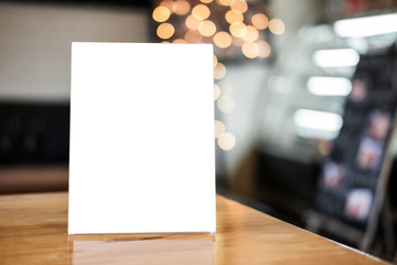 Mock up blank menu frame on table in coffee shop stand for your text of display your product