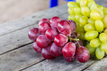 Red grapes on wooden table - vintage filter.