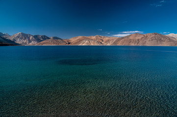 View of Lake Pangong with beautiful mountains in blue sky and reflection. Leh Ladakh, India
