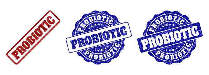 PROBIOTIC scratched stamp seals in red and blue colors. Vector PROBIOTIC labels with distress style. Graphic elements are rounded rectangles, rosettes, circles and text labels.