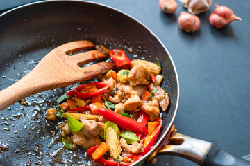 Chicken spicy stir fried still in a pan, Thai food