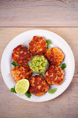 Salmon burgers with avocado salsa and lime. Salmon cakes. Fish patties. overhead, vertical