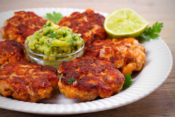 Salmon burgers with avocado salsa and lime. Salmon cakes. Fish patties. horizontal