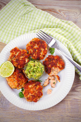 Salmon burgers with avocado salsa and lime. Salmon cakes. Fish patties. overhead, vertical