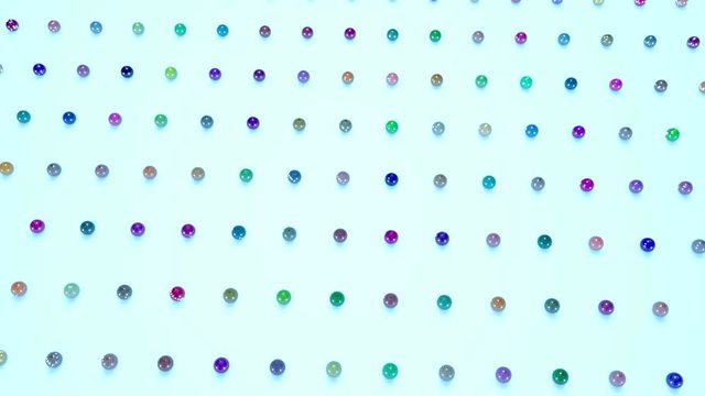 christmas balls on surface in a rows. 3d animation for new year compositions or background with depth of field. amera moves smoothly above the surface. Multi colored 1