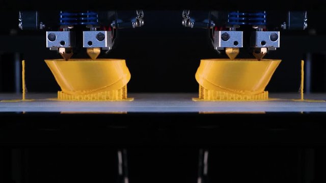 3d printer prints the two model of the hands, process of printing hands prosthesis on the 3d printer. Accelerated video. 4k footage.
