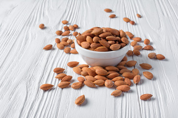 Whole almond in white bowl for healthy nutrition