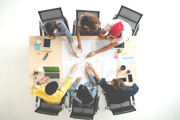 Top view of creative diverse people agree result together. Overhead view of young creative team, start up colleagues group or college student meeting and voting agree opinion by pointing hand at desk.