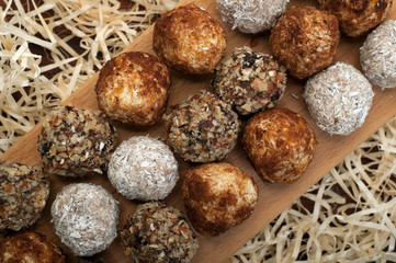Hand-made sweets made from dried fruits, nuts and seeds (without sugar). Macro shooting. Delicious...