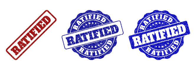 RATIFIED scratched stamp seals in red and blue colors. Vector RATIFIED imprints with grainy effect. Graphic elements are rounded rectangles, rosettes, circles and text titles.