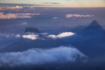 shadow of the conical mountain Adam's Peak or Sri Pada at sunrise - sacred buddhist place. Sri Lanka