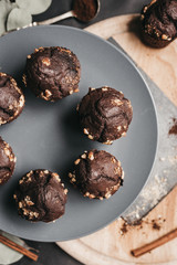 Vertical shot of food flat lay with chocolate muffins on dark background.