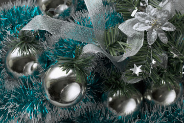 Christmas decoration balls in silver color, turquoise tinsel. Holiday New Year background