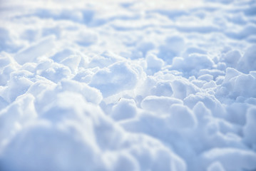 Beautiful Christmas natural image. Snowdrifts of snow in the morning light in the cold outdoors, selective focus. Winter landscape, snow background, texture.