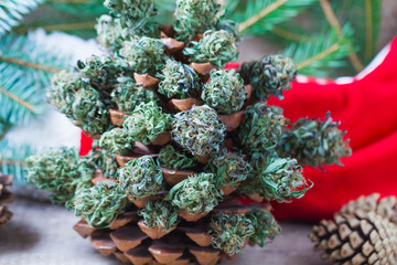 santa red Christmas boot with marijuana on a wooden table on a Christmas New Year's background