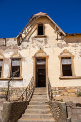 Fototapeta premium Kolmanskuppe, aslo known as Kolmanskop, a diamond mining ghost town on the Skeleton Coast of Namibia.