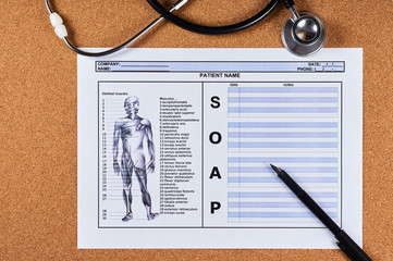 Patient SOAP note sheet, stethoscope and pen on corkwood background. Flat lay.