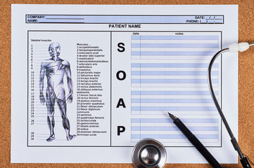 Patient SOAP note sheet, stethoscope and pen on corkwood background. Flat lay.