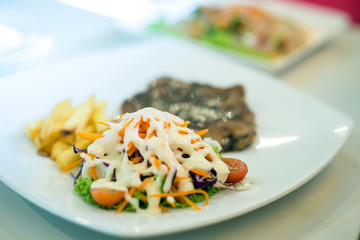 Grilled steaks and vegetable salad