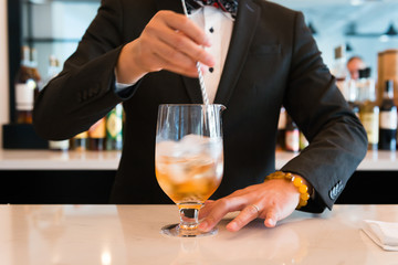 Bartender Stirring a Drink on the Counter Fancy Tuxedo High Scale Restaurant