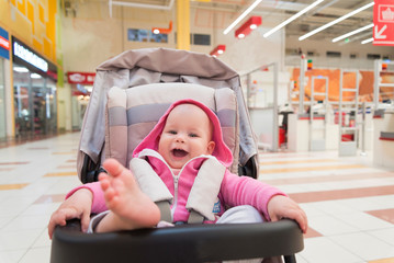 baby in the stroller lifted his leg up