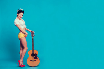pin-up girl holding the guitar