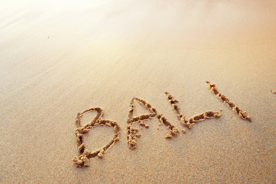 Bali letters handwritten in sand on beach
