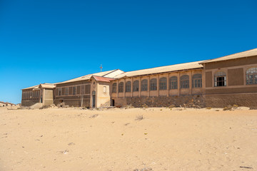 Fototapeta premium Kolmanskuppe, aslo known as Kolmanskop, a diamond mining ghost town on the Skeleton Coast of Namibia.