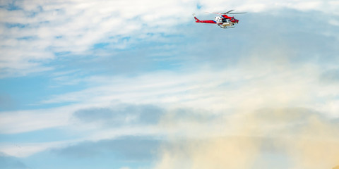 Helicopter flying on a cloudy sky over La Jolla CA