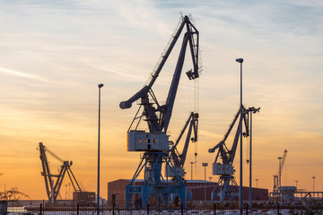 Cranes of the port at sunrise in Sagunto, Valencia, Spain