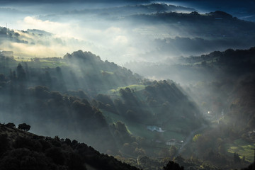 Rays of Sun in the mist of dawn in Karrantza -Bizkaia