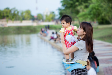 Mother and her child enjoy the summer in green park outdoor.