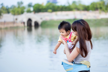 Mother and her child enjoy the summer in green park outdoor.