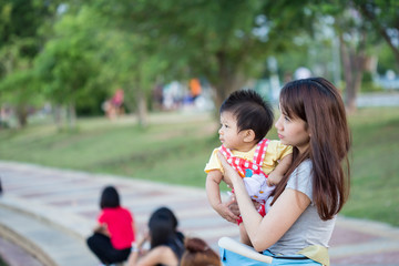 Mother and her child enjoy the summer in green park outdoor.