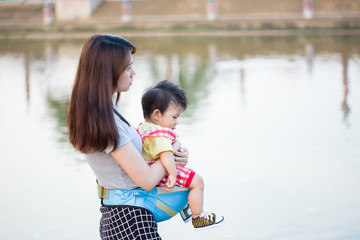 The mother carries the child in her arms