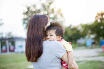 Young mother is holding her little baby