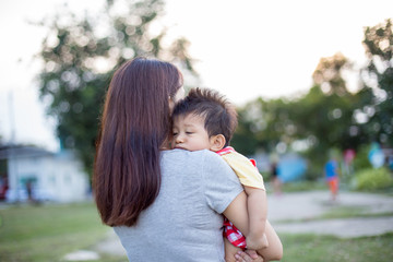 The mother carries the child in her arms