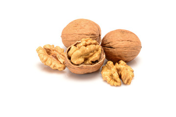 Walnuts and kernels, two whole walnuts and kernels, close-up macro, isolated on a white background.